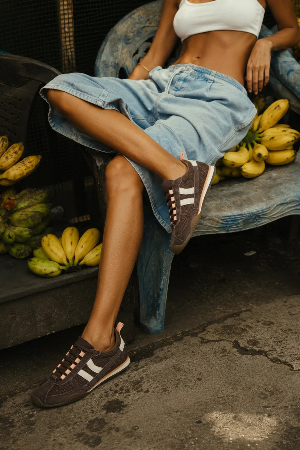Zapatillas Nilo Raw Cacao de Coolway para mujer puestas con vaqueros, en marrón chocolate y estética deportiva retro